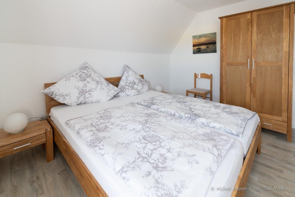 Doppelschlafzimmer mit Holzmöbeln – Ferienwohnung 5 Personen Kappeln